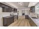 Modern kitchen with dark cabinets, quartz countertops, and stainless steel appliances at 3314 El Camino Real, Las Vegas, NV 89121