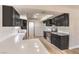 Modern kitchen featuring dark cabinetry, quartz countertops, and stainless steel appliances at 3314 El Camino Real, Las Vegas, NV 89121