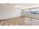 Bright living room featuring light walls, wood-look floors, and a stylish light fixture at 3314 El Camino Real, Las Vegas, NV 89121