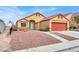 House exterior with orange garage door and rock landscaping at 3434 Empress Diamond Dr, North Las Vegas, NV 89032