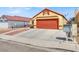 House exterior with orange garage door and rock landscaping at 3434 Empress Diamond Dr, North Las Vegas, NV 89032