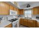 Bright kitchen featuring white appliances and oak cabinets at 3604 Lisandro St # 201, Las Vegas, NV 89108