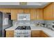 Well-equipped kitchen, featuring oak cabinets and white appliances at 3604 Lisandro St # 201, Las Vegas, NV 89108