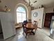 Charming dining area with a round wooden table and window seat at 3830 Passionfruit St, North Las Vegas, NV 89032