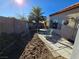 Small patio with table and chairs, partial landscaping at 3830 Passionfruit St, North Las Vegas, NV 89032