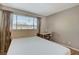 Well-lit bedroom showcases a neutral palette and a window with views of the outdoors at 4241 Gannet Cir # 205, Las Vegas, NV 89103