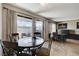 Dining area adjacent to an office setup with natural lighting and tile floors at 4241 Gannet Cir # 205, Las Vegas, NV 89103