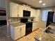 Modern kitchen featuring granite countertops and white cabinetry at 4241 Gannet Cir # 205, Las Vegas, NV 89103