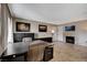 Open living room featuring tile flooring, fireplace, and a dark wood desk setup at 4241 Gannet Cir # 205, Las Vegas, NV 89103