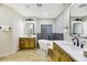 Spa-like bathroom featuring a freestanding tub, dual vanities, and wood cabinets at 4541 Largo Cantata St, Las Vegas, NV 89135