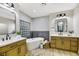 Elegant bathroom with double vanities and a soaking tub at 4541 Largo Cantata St, Las Vegas, NV 89135