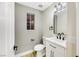 Modern powder room with white vanity and black accents at 4541 Largo Cantata St, Las Vegas, NV 89135