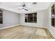 Bright bedroom with wood floors, ceiling fan, and large windows at 4541 Largo Cantata St, Las Vegas, NV 89135