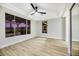 Spacious bedroom with wood floors, a ceiling fan, and sliding mirrored closet doors at 4541 Largo Cantata St, Las Vegas, NV 89135