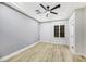 Well-lit bedroom featuring wood floors, a ceiling fan, and a window with shutters at 4541 Largo Cantata St, Las Vegas, NV 89135