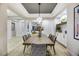 Modern dining room with statement lighting and built-in shelving at 4541 Largo Cantata St, Las Vegas, NV 89135