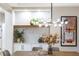 Bright dining room with modern light fixture and wood table at 4541 Largo Cantata St, Las Vegas, NV 89135