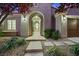 Elegant entryway with arched doorways and landscaping at 4541 Largo Cantata St, Las Vegas, NV 89135