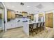 Modern kitchen with large island, white cabinets, and light wood accents at 4541 Largo Cantata St, Las Vegas, NV 89135