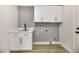 Bright laundry room with white cabinets and quartz countertops at 4541 Largo Cantata St, Las Vegas, NV 89135