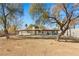 House backyard view with mature trees and a large yard at 4840 Conough Ln, Las Vegas, NV 89149