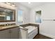 Bathroom with double vanity, soaking tub, and stone tile at 4840 Conough Ln, Las Vegas, NV 89149