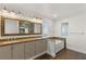 Bathroom with double vanity, soaking tub, and stone tile at 4840 Conough Ln, Las Vegas, NV 89149