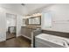 Elegant bathroom with double vanity, soaking tub, and walk-in shower at 4840 Conough Ln, Las Vegas, NV 89149