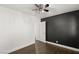 Bedroom with dark accent wall and ceiling fan at 4840 Conough Ln, Las Vegas, NV 89149