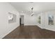 Spacious dining room with dark hardwood floors and a modern chandelier at 4840 Conough Ln, Las Vegas, NV 89149