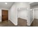 Bright hallway with dark brown tile floor and wooden door at 4840 Conough Ln, Las Vegas, NV 89149