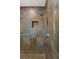 Walk-in shower with multi-colored tile and niche at 4840 Conough Ln, Las Vegas, NV 89149