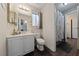 Well-lit bathroom featuring a vanity with a mirror, toilet, and shower with modern fixtures and neutral colors at 504 Crony Ave, Henderson, NV 89011