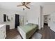 Main bedroom with a ceiling fan, green bedding, and a view to backyard at 504 Crony Ave, Henderson, NV 89011