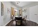 Dining area featuring a round glass table, chairs, and natural light at 504 Crony Ave, Henderson, NV 89011