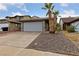 House exterior with a two car garage and palm trees at 504 Crony Ave, Henderson, NV 89011