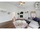 Cozy living room with a gray sofa, white brick fireplace, and wood-look flooring at 504 Crony Ave, Henderson, NV 89011