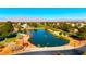 Aerial view of community with pond, golf course, and mountains in background at 5305 Singing Hills Dr, Las Vegas, NV 89130