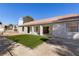 Artificial turf backyard with covered patio and view of home at 5305 Singing Hills Dr, Las Vegas, NV 89130