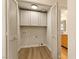 Bright laundry room with cabinets and vinyl flooring at 5305 Singing Hills Dr, Las Vegas, NV 89130