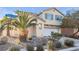 Two-story house with a white garage door and palm trees at 5445 Tallulah Falls St, North Las Vegas, NV 89081