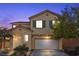 Two-story house with a white garage door and landscaping at 5445 Tallulah Falls St, North Las Vegas, NV 89081