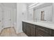 Modern bathroom with dark gray vanity, white countertop, and marble shower at 59 E Agate Ave # 406, Las Vegas, NV 89123