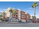 Building exterior showcasing a modern apartment complex with palm trees and ample parking at 59 E Agate Ave # 406, Las Vegas, NV 89123