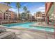 Community pool with comfortable lounge chairs for sunbathing at 59 E Agate Ave # 406, Las Vegas, NV 89123