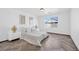 Bright bedroom with herringbone floors, a large window, and modern decor at 610 Roberta Alecia Ave, North Las Vegas, NV 89031