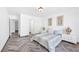 Spacious bedroom featuring herringbone floors, ample natural light, and modern decor at 610 Roberta Alecia Ave, North Las Vegas, NV 89031