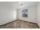 Cozy bedroom with herringbone floors, window view, and neutral decor at 610 Roberta Alecia Ave, North Las Vegas, NV 89031