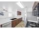 Bright, eat-in kitchen with modern appliances, ample counter space, and stylish herringbone floors at 610 Roberta Alecia Ave, North Las Vegas, NV 89031