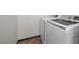 Laundry area with modern appliances and herringbone-patterned tile flooring at 610 Roberta Alecia Ave, North Las Vegas, NV 89031